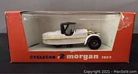 1923 Morgan die-cast car in original red box with window showing white model with gold accents and black wheels.