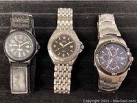 Three watches shown together: two Swiss Military men's wristwatches and one Casio Edifice chronograph watch on metal band
