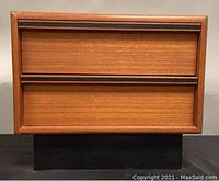 Front view of teak nightstand showing two drawers with horizontal handles and minor surface imperfections