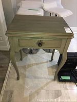 Antique sewing cabinet, front view showing drawer with loose knob