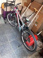 Full side view of the mountain bike showing frame, tires, handlebars, and rear kickstand.