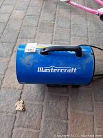 Front view of blue Mastercraft portable heater with carry handle and brand logo.