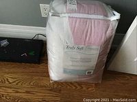 Packaged Truly Soft Everyday Full/Queen 3 Piece Comforter Set in protective plastic wrapping with label visible.