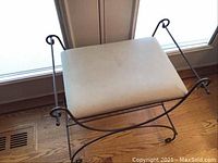 Front angled view of stool showing metal frame and fabric seat