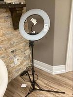 Full view of the halo ring light on tripod stand showing the complete setup with power cord.