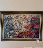 Front view of the framed print hanging on a wall, showing the full colorful floral and palm leaf design.