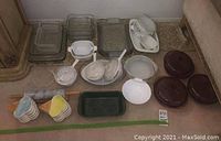 Overview of assorted glass and ceramic bakeware pieces including Pyrex-style dishes, ceramic lidded dishes, decorative bowls and plates.