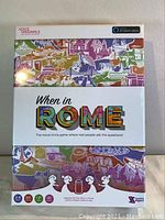 Front side of the boxed travel trivia game When in Rome for Amazon Alexa showing colorful landmark illustrations and game details.