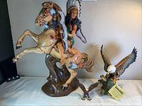 Photo showing the full lot with woman chief on horse and two eagle statues on a table.