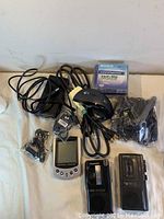 Overview of the lot showing cables, Sony mini DVDs, wired mouse, personal organizer, and cassette recorders.