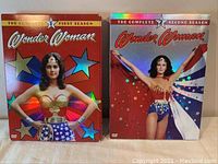 Front view of two boxed DVD sets: Wonder Woman Season 1 and Season 2, showing original colorful artwork featuring Wonder Woman in classic outfit.
