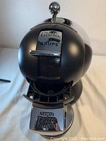 Front view showing the Nescafe Dolce Gusto and KRUPS branded round coffee maker with lever and drip tray.