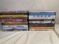 Stack of 20 Punjabi and Bollywood DVD movie titles showing colorful spines in two columns. Titles include various well-known movies and film awards from 2006.