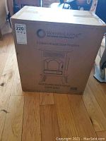 Boxed Warm-Living 3-Sided Infrared Stove Fireplace showing front with model and color info.