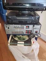 Front and rear view of Sharp UCH8100 VCR stacked on Sony STR-K900 AV receiver showing connections and controls.