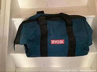 Blue Ryobi carrying bag with black straps and red Ryobi logo