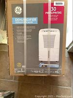 Photo of GE 30 pint dehumidifier original box showing front label with product image and key features.