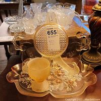 Two pink glass platters and one pink glass goblet arranged on a table, showcasing the size and style of the platters and goblet.