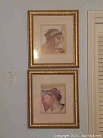 Two 15x17 gold framed classical portrait prints showing historical style head and shoulders of individuals.