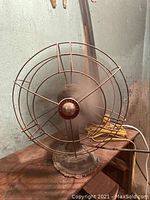 Front view of vintage Westinghouse metal fan showing protective metal cage and base.