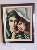 Full view of the framed acrylic painting depicting two women in Art Deco style.