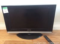 Front view of the 26-inch Samsung LED TV showing black bezel and stand base.