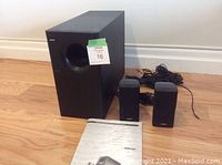 Subwoofer, two satellite cubes, manual and speaker wire