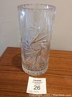 Front view of a large clear leaded crystal vase with detailed starburst and spiral cut designs, showing size and condition.