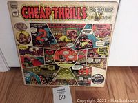 Front cover of 'Cheap Thrills' album with colorful comic-style artwork and band name