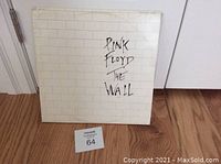 Front cover of Pink Floyd "The Wall" double vinyl LP album showing brick wall design and album title text.
