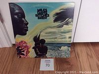 Front cover of the Bitches Brew album sleeve showing surreal artwork of figures and nature.