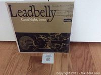 Front cover of Leadbelly vinyl album "Good Night, Irene" featuring title, artist name, and image of guitar.