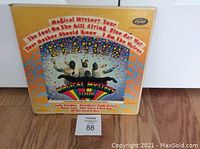 Front cover of the Magical Mystery Tour vinyl LP showing colorful cover art and album title.