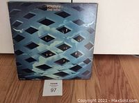 Front of the album cover showing blue geometric cutout pattern design.