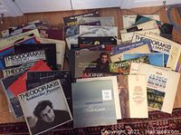 Photo showing a large collection of 55 vinyl LPs spread out, featuring multiple classical music albums including Theodorakis, Placido Domingo, Andre Gagnon, and Soviet Union recordings.