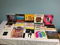Overview of all 30 jazz LPs by various artists spread on a table.