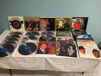 Top view of all 30 jazz LP records laid out on a table showing album covers and some records.