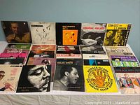 Wide shot of 15 assorted jazz LP covers laid out on table