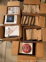 Photo of six open cardboard boxes filled with numerous Scientific American magazines showing their covers and organized upright in file holders.