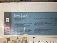 Label on original box listing detailed technical specifications and features of the Power Mac G4 computer including CPU, memory, drive, networking, and included accessories.