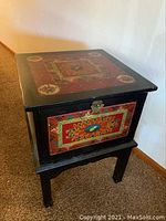 Full three-quarter view of table showing painted panels, legs and latch