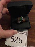 Ring in presentation box with auction tag