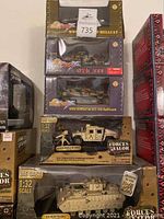 Stacked view of five boxed vehicles showing variety in packaging