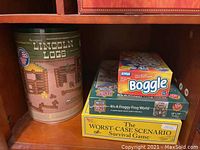 Lincoln Logs set and boxed board games including Boggle and The Worst-Case Scenario Survival Game