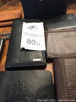 Overview of multiple wallets on table showing several branded and unbranded styles