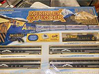 Bachmann McKinley Explorer HO scale train set in original box, featuring locomotive and passenger cars with Alaska mountain graphics.