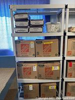 Full view of shelving unit with multiple cardboard boxes stacked on shelves (boxes not included).