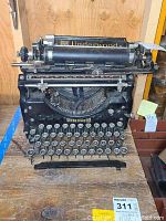 Front angled view of the Underwood typewriter showing keys, ribbon cover, and brand name.