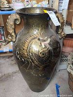 Front view of the large vase showing the dragon painting and the overall shape with wide opening and sculptural handles.