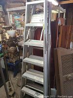 6ft aluminum folding step ladder standing upright, showing multiple wide steps and top platform